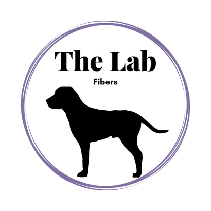 The Lab Fibers Logo. A purple circle containing black text "The Lab Fibers" and a black lab silhouette.