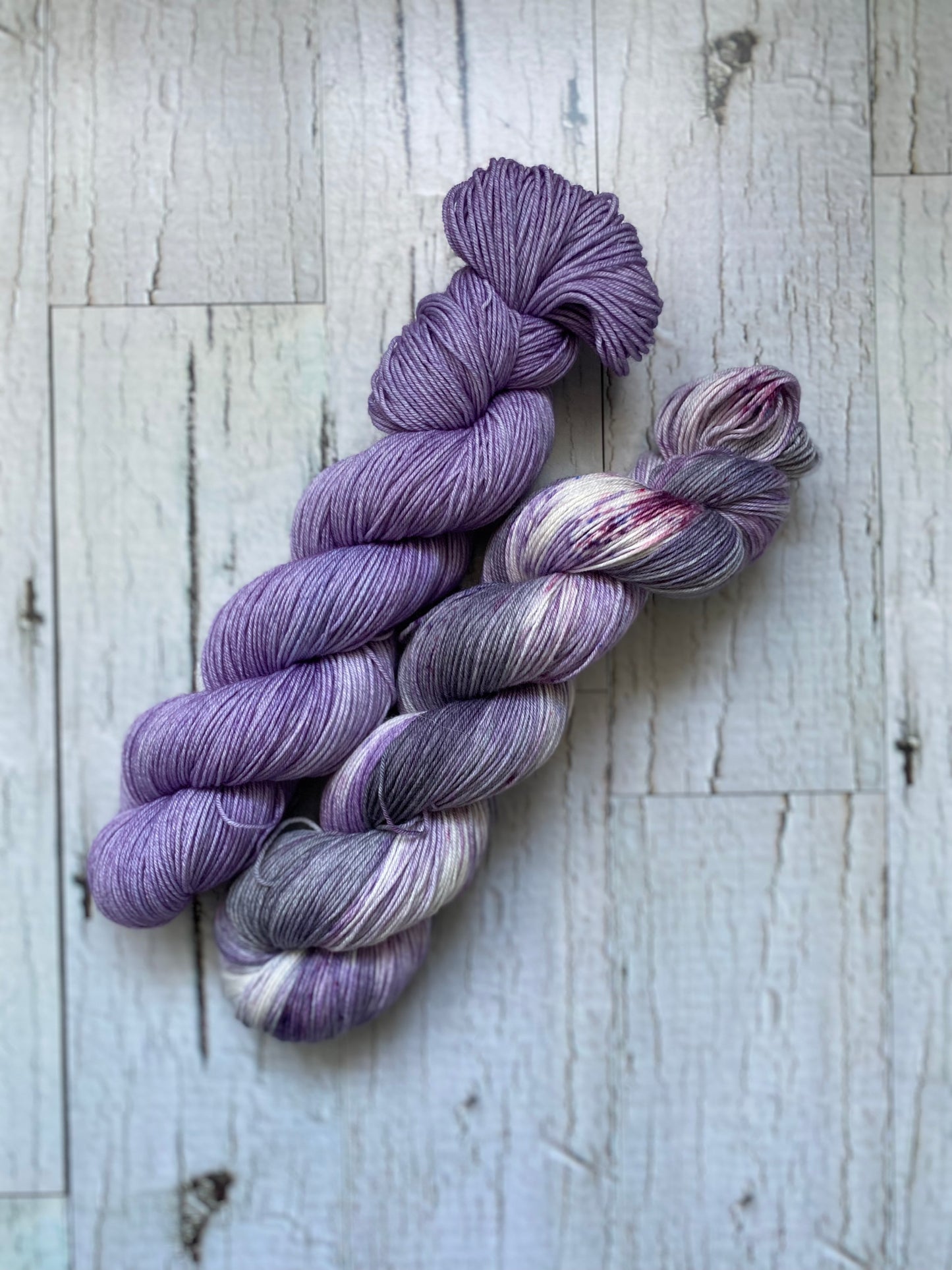 Two Skeins of Everyday Fingeringing, Wildflower on the left and Lilac Storm on the Right.
