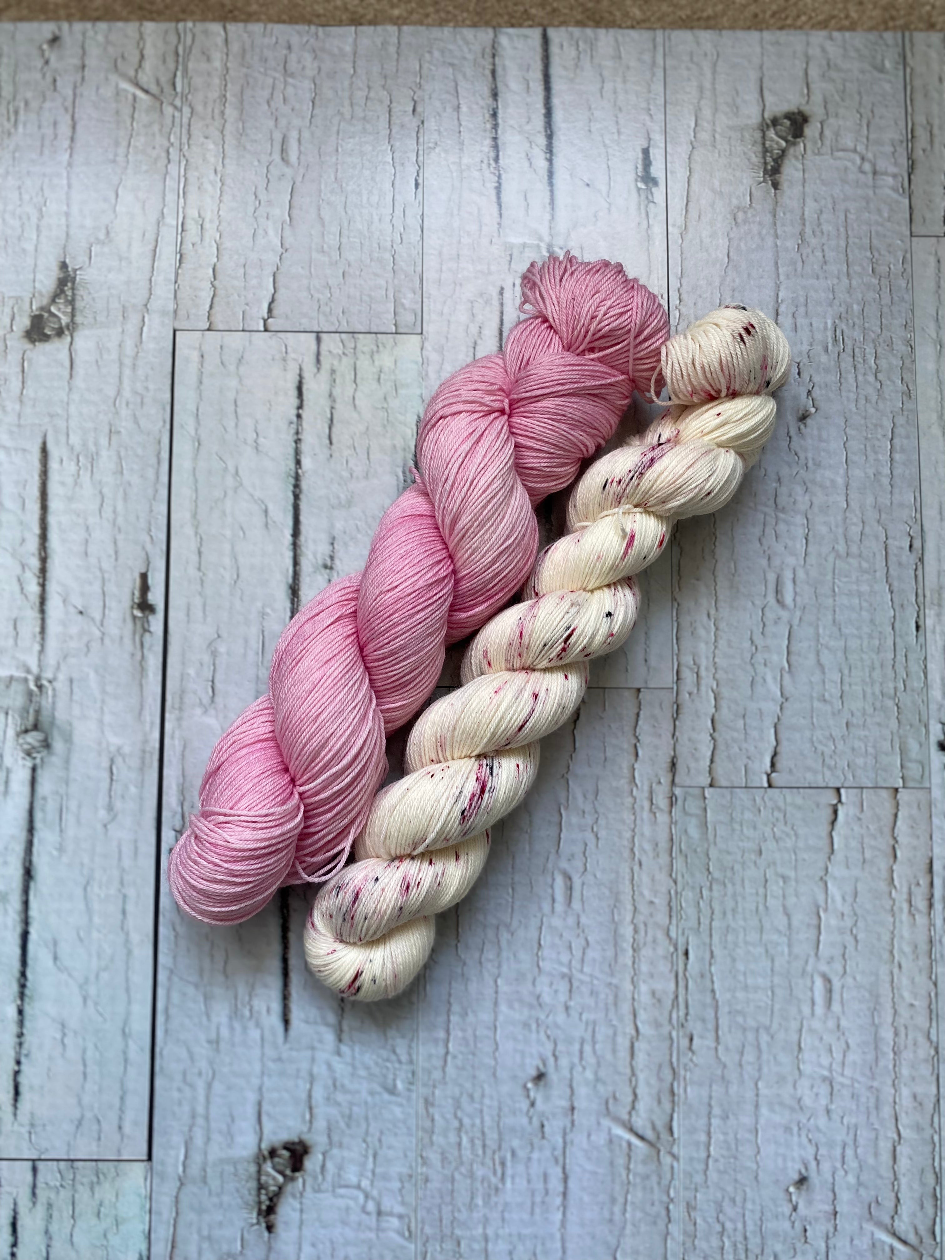 Two Skeins of Everyday Fingeringing, Flamingo on the left and Sparklepop on the Right.